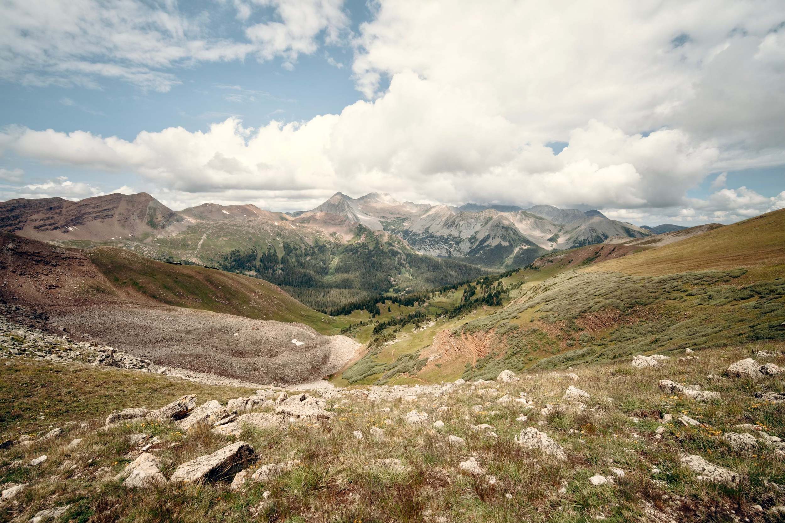 Atop Buckskin pass looking ahead at a sweeping panorama of mountains