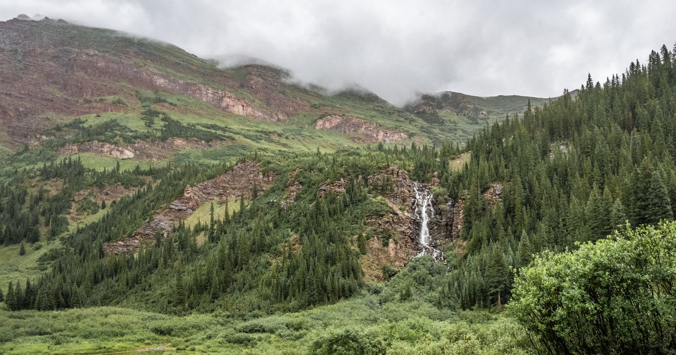 Waterfall seen in the background of a misty Fravert Basin