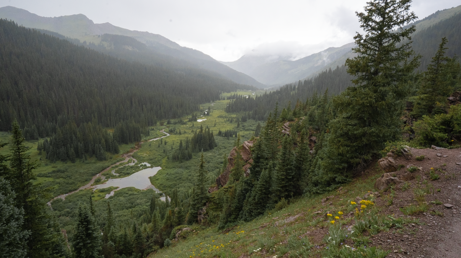 Looking back at the massive Fravert basin with gray skies behind
